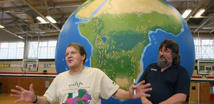 Dr. James Hayes-Bohanan and Dr. Vernon Domingo demonstrating an Earth View Globe in the Kelly Gymnasium